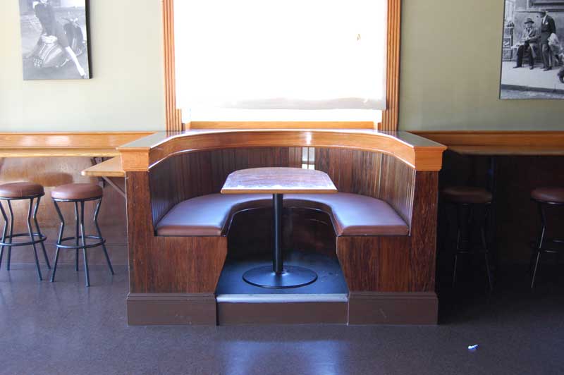 Semi-circular booth with wooden framing.
