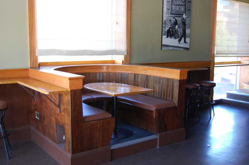 Semi-circular booth with table, from side.