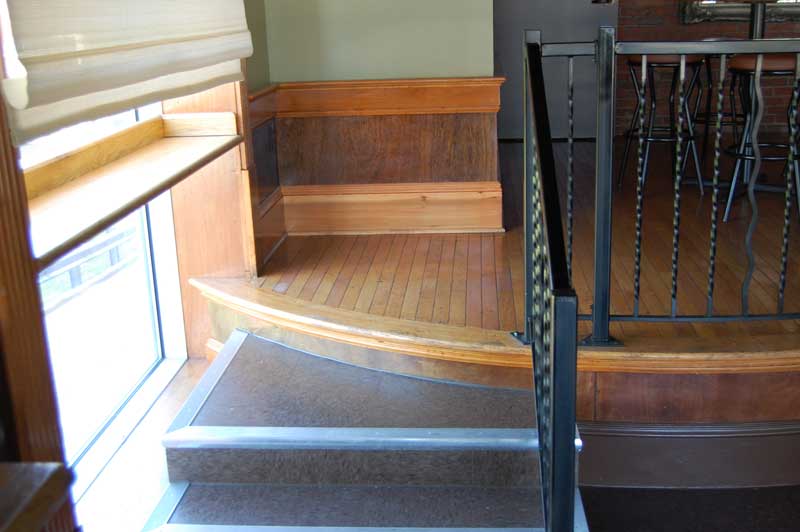 Wooden steps up to curved platform.