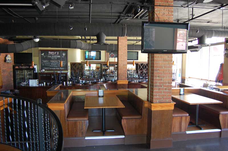 Long view of bar with all the custom wood funishings.